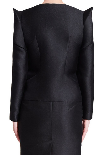 Women's black formal jacket with long sleeves and centered front buttons. Oragami style geometric design with padded shoulders